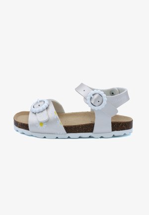 Sandale blanche ornée de motifs floraux, dotée de deux boucles réglables, d'une semelle en liège et d'une semelle extérieure blanche. Conçue pour le confort et la durabilité.