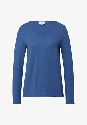 Pikend varrukatega V-kaelusega t-särk sinises värvitoonis. Valmistatud pehmest, tekstureeritud materjalist, millel on peen heather muster ning väike külgmine sõlm detaile hemil.