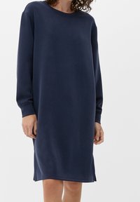 Mörkblå långärmad sweatshirtklänning med rund halsringning, ribbade manschetter och sidoflikar för ökad rörelsefrihet. Mjuk, slät textur.