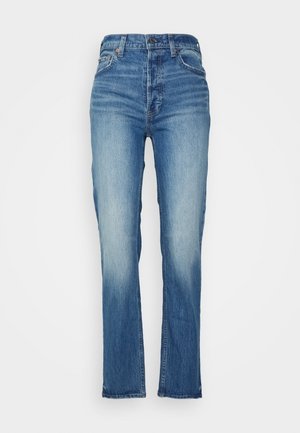 Korkeavyötäröiset siniset farkut, joissa on haalistuneet etu-reidet ja suora lahje, varustettu napilla ja vetoketjulla sekä etutaskuilla.