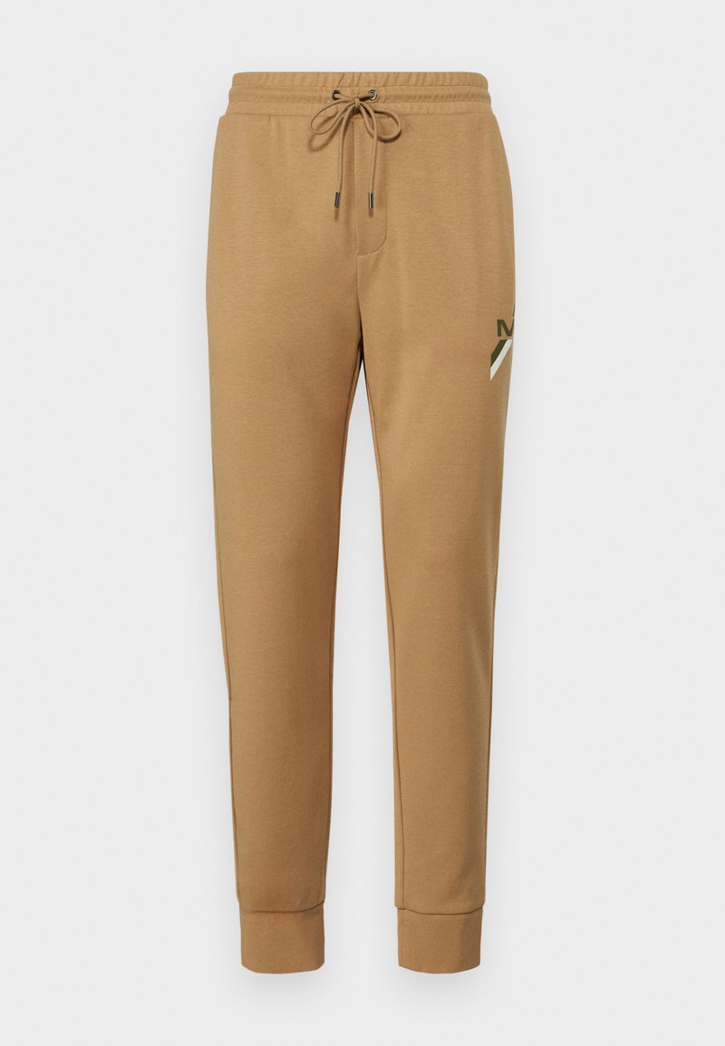 Pantalones de chándal marrones de algodón con cinturilla elástica, cordón, piernas ajustadas y un pequeño logotipo en el muslo izquierdo.