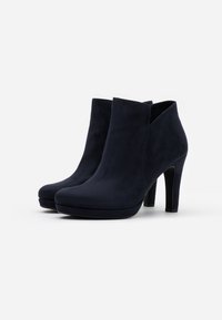 Pair of black suede ankle boots with high heels and slightly pointed toes, set against a plain white background.