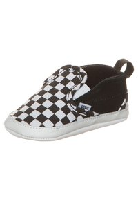 Chaussure à enfiler à motif damier noir et blanc avec une tige en toile, des accents élastiques sur les côtés et une semelle en caoutchouc blanche. Comprend une languette de traction à l'arrière.