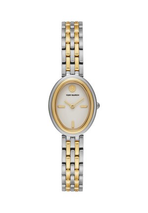 Oval Tory Burch armbåndsur med tofarvet sølv- og guldbånd og hvid urskive med gyldne timeindikatorer og visere.