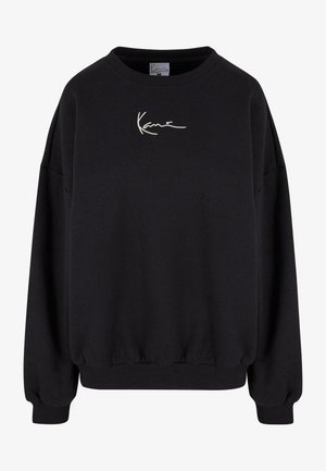 Sweatshirt noir avec un col rond, des poignets côtelés, des épaules tombantes et un logo blanc brodé sur la poitrine. Tissu doux avec une coupe décontractée.