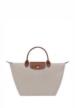 Light gray tote bag made of durable fabric. Features a brown leather handle and flap with a gold snap button. Zippered side compartment included.