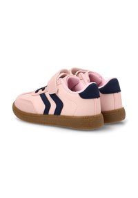Zapatillas de deporte rosas con acentos en marino, que cuentan con una correa de velcro y dos franjas en marino a los lados, suela de goma texturada y cuello acolchado.