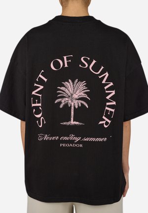 Sort bomulds T-shirt med et stort pink grafisk motiv af et palmetræ med teksten "DUFT AF SOMMER" og "Aldeles uendelig sommer" nedenfor.