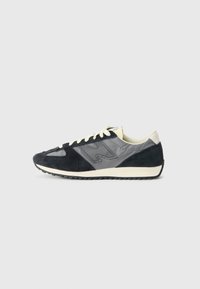 Suede and fabric sneaker in navy and gray, featuring a rounded toe, lace-up closure, and rubber sole with textured tread.