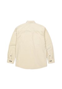 Lichtbeige langemouwen shirt met een button-down kraag, enkele achterkant yoke en knoopmanchetten. Zachte, gestructureerde stof met een gladde afwerking.