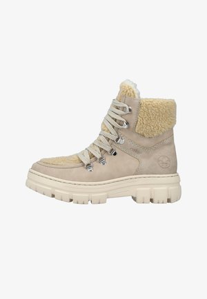 Stivali alla caviglia beige con colletto in finta pelliccia testurizzata, design con lacci e suola in gomma spessa con un motivo ad alta aderenza.
