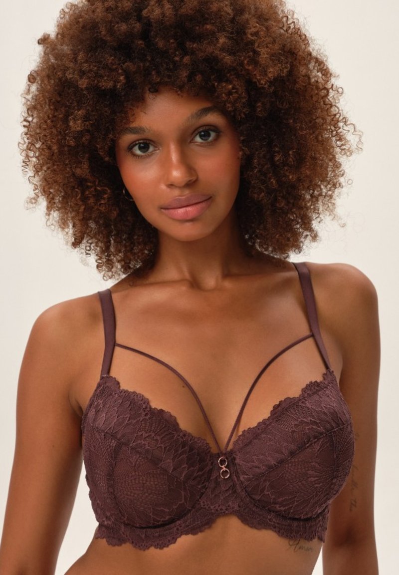 Burgundowa koronkowa braletka z motywem kwiatowym, fiszbinami, ozdobnymi ramiączkami i centralnym metalowym akcentem. Gładki materiał z misternymi detalami.