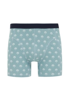 Kék boxeralsó, sötétkék derékkal, fehér pálmafa mintával az egész anyagon. Puha szövet, szűkített fazon.