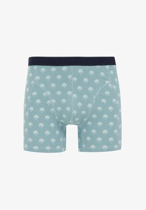 Kék boxeralsó, sötétkék derékkal, fehér pálmafa mintával az egész anyagon. Puha szövet, szűkített fazon.