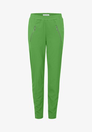 Heldengroene broek met een taps toelopende pasvorm, elastische tailleband en twee ritszakken aan de zijkant. Gemaakt van een gladde, lichte stof.