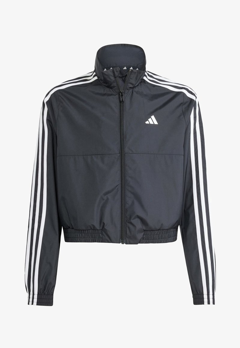 Veste de survêtement noire courte zippée avec des bandes blanches Adidas sur les manches et le logo sur la poitrine gauche, poignets et taille élastiques.