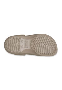 Suola beige chiaro di Crocs con una battistrada decorata, caratterizzata da scanalature profonde e nubbini circolari per una buona aderenza. Bordi leggermente rialzati nel tallone.