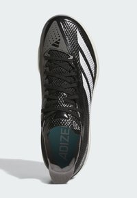 Black athletic shoe with mesh upper, white stripes, and grey accents. Features a textured toe cap and a padded tongue for comfort.