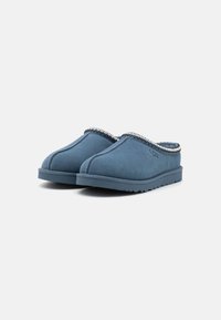 Blue suede slip-on slippers with a textured finish and decorative stitching along the collar. Rubber outsole for traction.