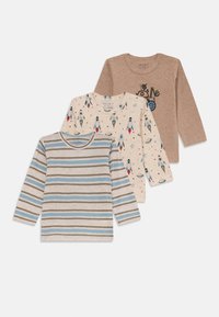 Three long-sleeve children's shirts: one striped in blue and beige, one cream with rocket designs, one solid brown with a cartoon graphic.