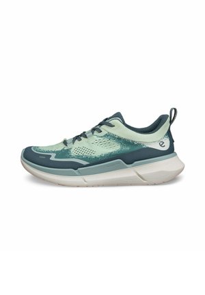 Hellgrüner und dunkelblauer Sport-Schuh mit Mesh-Obermaterial, gepolsterter Kragen, Schnürsenkeln und Gummisohle. Verfügt über ein strukturiertes Design und eine Zuglasche.