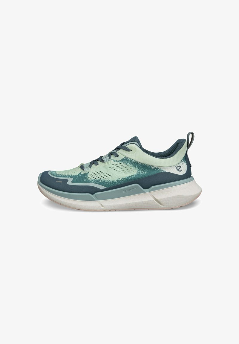 Hellgrüner und dunkelblauer Sport-Schuh mit Mesh-Obermaterial, gepolsterter Kragen, Schnürsenkeln und Gummisohle. Verfügt über ein strukturiertes Design und eine Zuglasche.