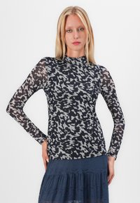 Long-sleeve top in a black and gray abstract pattern. Features a mock neck and sheer sleeves; made from a lightweight, textured fabric.