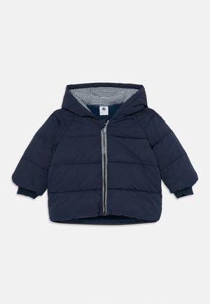 Veste rembourrée pour tout-petit de couleur bleu marine avec capuche, fermeture éclair à l'avant et doublure en tissu rayé à l'intérieur de la capuche.