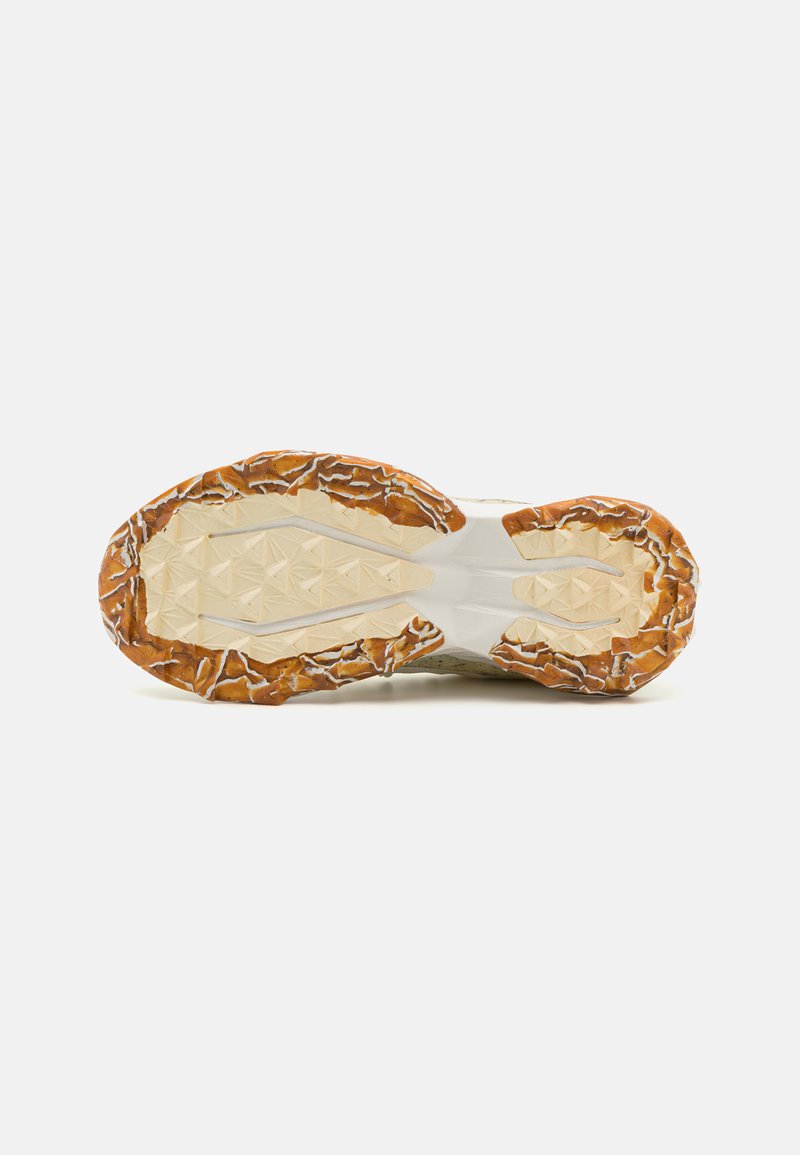Semelle de chaussure avec une surface en caoutchouc texturé; dotée d'un motif géométrique dans des tons beige clair et marron; conception durable et robuste.