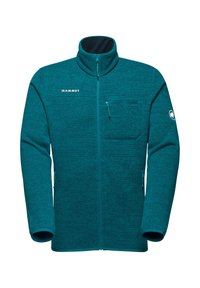 Giacca in pile teal con colletto alto, zip frontale e tasca sul petto. Caratterizzata dal logo Mammut sul petto e sulla spalla. Tessuto testurizzato.