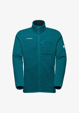 Giacca in pile teal con colletto alto, zip frontale e tasca sul petto. Caratterizzata dal logo Mammut sul petto e sulla spalla. Tessuto testurizzato.