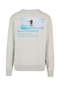 Világosszürke pulóver, hegyivezető grafikával, kék szöveggel a Kilimandzsáro-ról, bordás mandzsettákkal és aljjal.