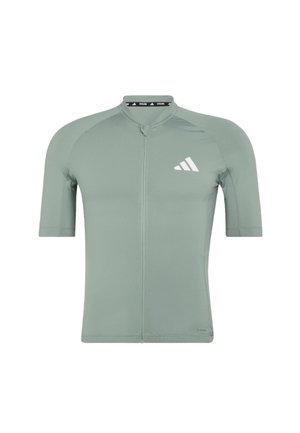 Maillot de cyclisme à manches courtes, vert clair, avec fermeture éclair à l'avant et logo Adidas blanc sur la poitrine gauche.