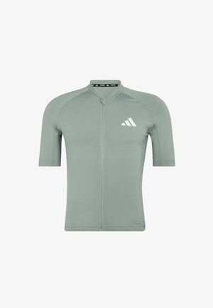 Koszulka kolarska z krótkim rękawem, jasnozielona, z zamkiem na przodzie i białym logo Adidas na lewym piersi.