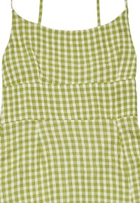 Green gingham dress with thin straps, fitted bodice, and gathered waist. Lightweight fabric with a checkered pattern and a soft texture.