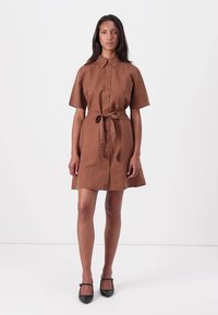Brun lin skjortekjole med korte ermer, knapper foran og belte i midjen. Har en avslappet passform og glatt tekstur. Enkelt design uten mønstre.