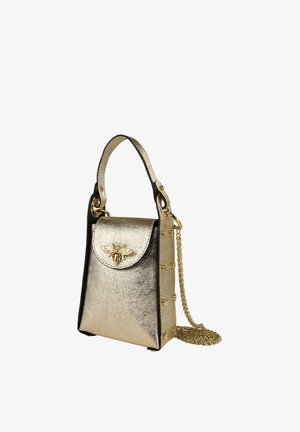 Small metallic gold handbag with top handle, bee emblem on front flap, side rivets, and gold chain strap coiled beside it.