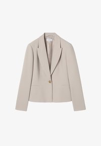 Blazer beige a medida con solapas con muesca, cierre con un botón dorado, mangas largas y dos bolsillos delanteros de ojal, etiqueta de talla 36 visible.