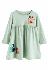 Ljusgrön långärmad klänning för småbarn med små vita trätryck, paljettälgansikte på bröstet, julgranar och presentdekorationer på kjolen.