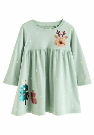 Ljusgrön långärmad klänning för småbarn med små vita trätryck, paljettälgansikte på bröstet, julgranar och presentdekorationer på kjolen.