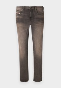 Skinny jeans in a faded black color, featuring five pockets, belt loops, and a zip fly. Material shows slight texture with subtle whiskering.