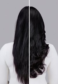 Long black hair, left side straight and unstyled, right side features soft curls, shown against a light gray background, with a white top.