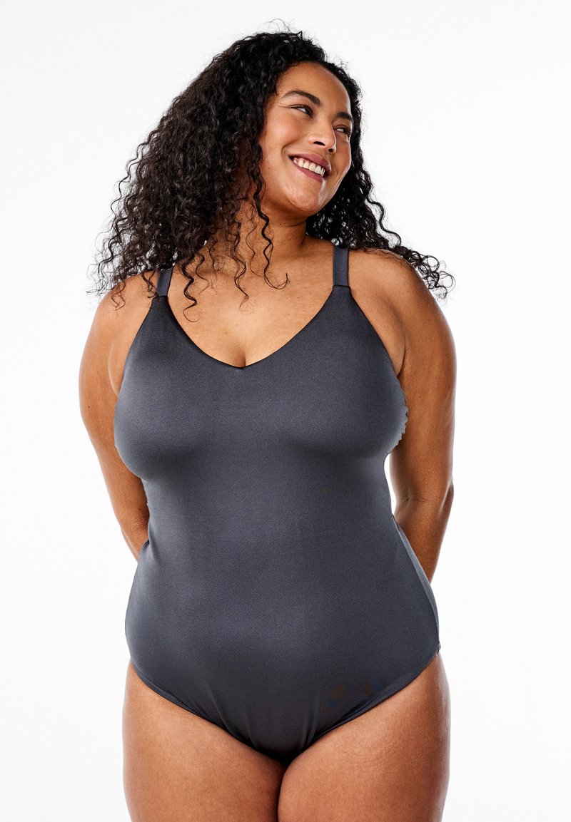 Tumši pelēks viengabala peldkostīms, izgatavots no gludas auduma, ar regulējamām siksnām un V veida kakla izgriezumu, nodrošinot pieguļošu siluetu.