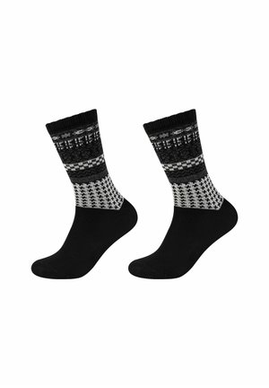 Schwarze Socken mit einem gemusterten grauen und weißen Knöchelbereich. Mit einem gestrickten Design, das geometrische Formen und eine glatte Textur aufweist.