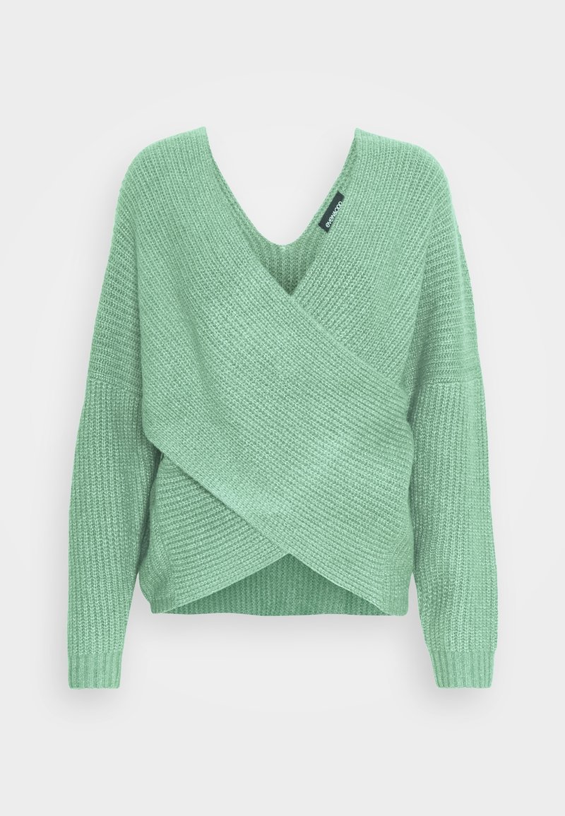 Pull en tricot vert à col en V profond, design cache-cœur, manches longues et motif texturé. Étiquette visible au niveau de l'encolure.