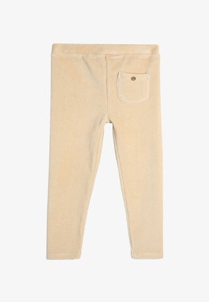 Beige corduroy legginsit, jotka ovat muotoiltu tiukasti, varustettu pienellä takataskulla napilla, sileä pinta ja ommeltu yksityiskohta saumoissa.