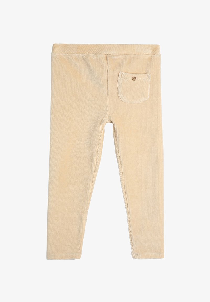 Beige Corduroy-Leggings mit einem taillierten Design, das über eine kleine Gesäßtasche mit einem Knopf, eine glatte Textur und gestickte Details entlang der Nähte verfügt.