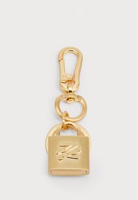 Gold-tone clasp keychain featuring a padlock design with a smooth finish and engraved detail. Includes an oval link for attachment.