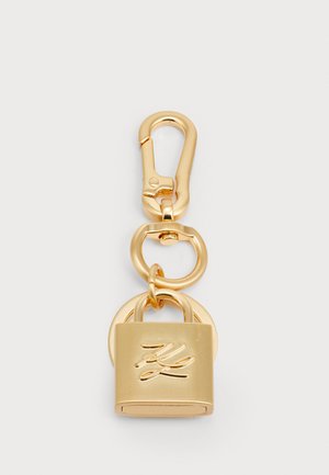 Gold-tone clasp keychain featuring a padlock design with a smooth finish and engraved detail. Includes an oval link for attachment.