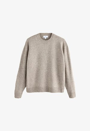 Un pull en tricot beige à col rond avec des poignets et un ourlet côtelés, présenté sur un fond blanc.